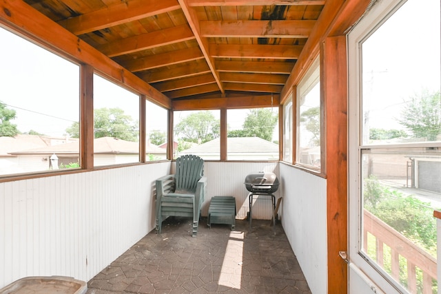 sunroom featuring vaulted ceiling, wood ceiling, and a healthy amount of sunlight