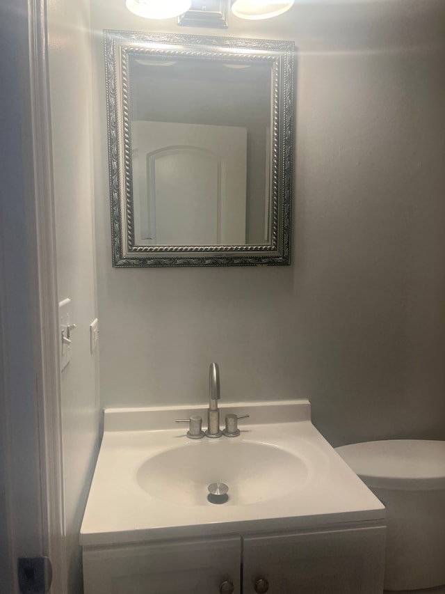 bathroom with toilet and vanity