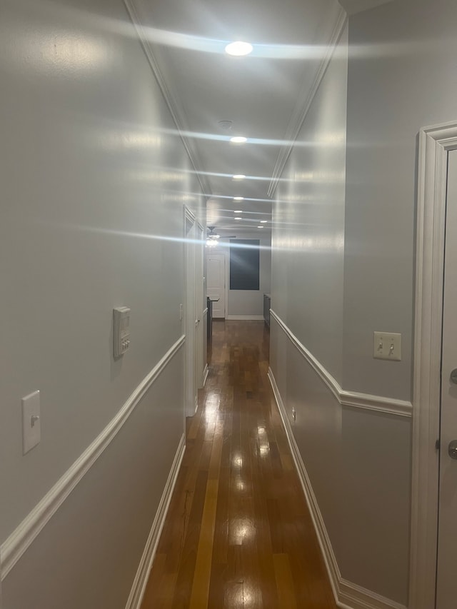 corridor featuring dark wood-style flooring and baseboards