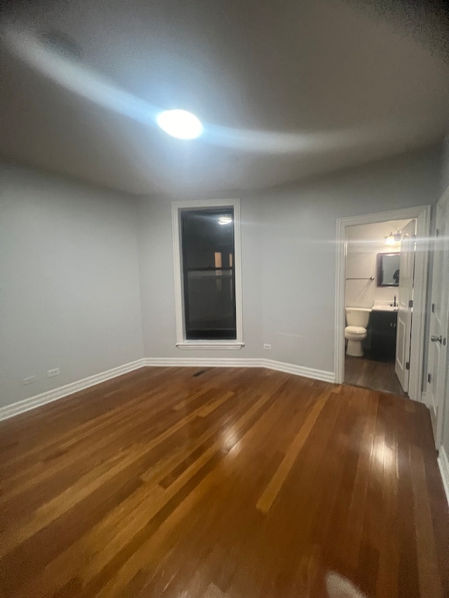 interior space with wood finished floors and baseboards