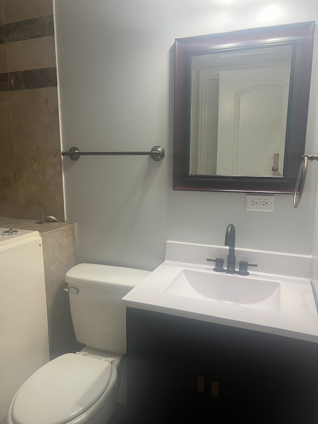 bathroom featuring vanity and toilet