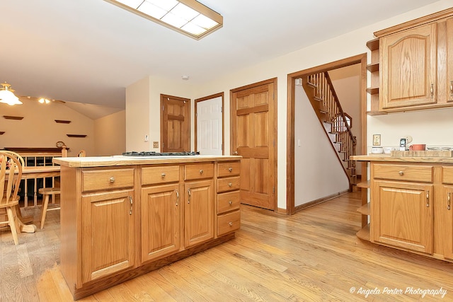 kitchen featuring a center island, light hardwood / wood-style floors, and light brown cabinets