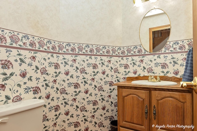 bathroom featuring vanity and toilet