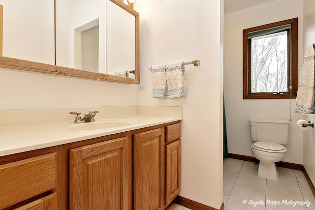 bathroom featuring tile patterned floors, vanity, and toilet