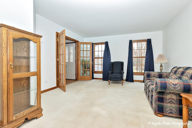 sitting room featuring french doors and carpet floors