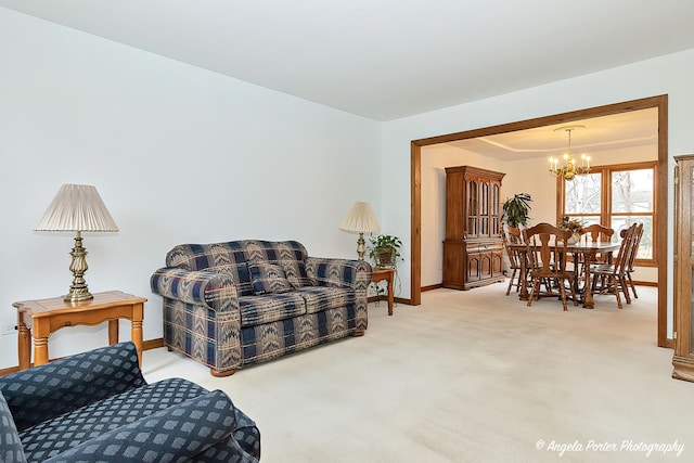 carpeted living room with a notable chandelier