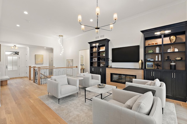11060 Lizmore Ln Unit 27B, Orland Park, IL 60467 - living area with light wood-type flooring, crown molding, a chandelier, a glass covered fireplace, and recessed lighting