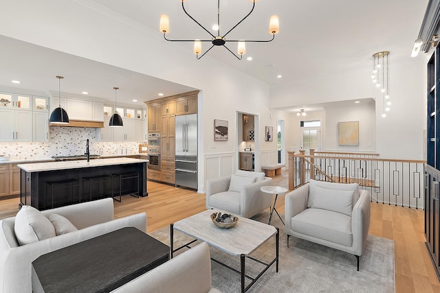 11060 Lizmore Ln Unit 27B, Orland Park, IL 60467 - living room featuring light wood-style floors, ornamental molding, a chandelier, recessed lighting, and a wainscoted wall