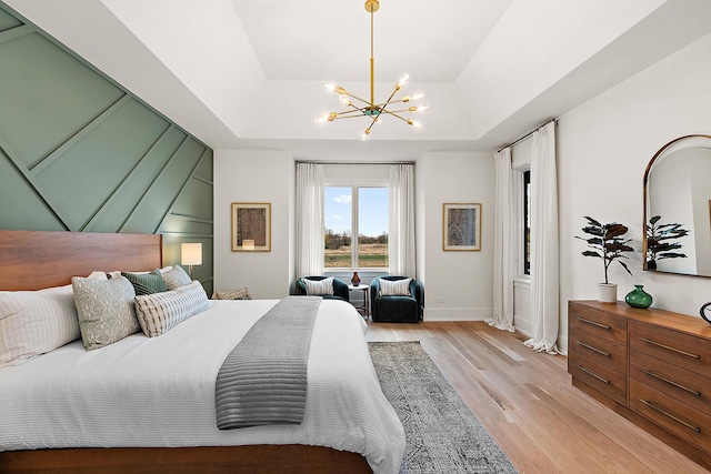 11060 Lizmore Ln Unit 27B, Orland Park, IL 60467 - bedroom with light wood-style floors, a chandelier, a raised ceiling, and baseboards
