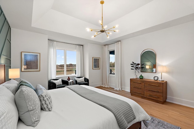 11060 Lizmore Ln Unit 27B, Orland Park, IL 60467 - bedroom featuring a chandelier, light wood-style floors, and baseboards