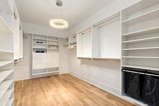 11060 Lizmore Ln Unit 27B, Orland Park, IL 60467 - spacious closet featuring a chandelier and light wood-type flooring