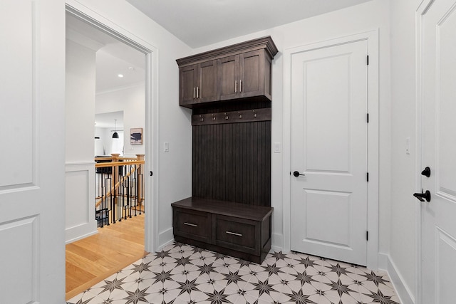 mudroom featuring ornamental molding and light hardwood / wood-style flooring