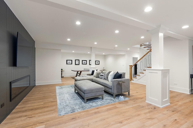 living room with light wood-type flooring and a fireplace