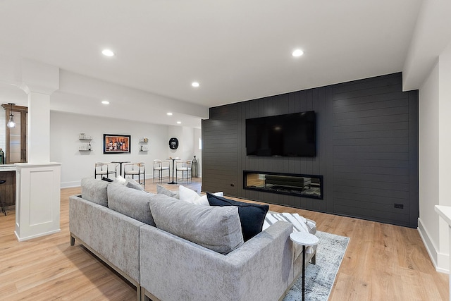 11060 Lizmore Ln Unit 27B, Orland Park, IL 60467 - living room featuring a large fireplace, light wood-style floors, recessed lighting, baseboards, and an accent wall