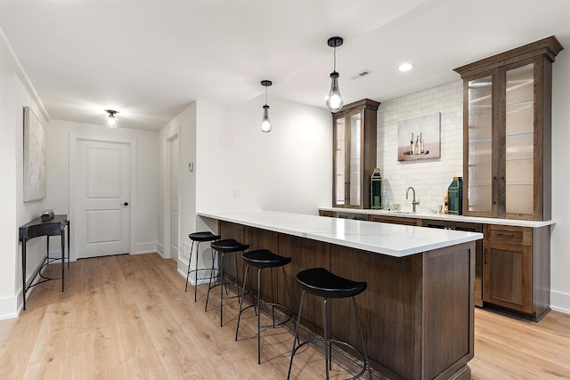 11060 Lizmore Ln Unit 27B, Orland Park, IL 60467 - bar featuring light wood-style floors, baseboards, decorative light fixtures, backsplash, and recessed lighting