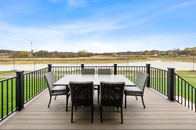 deck featuring a water view and a lawn