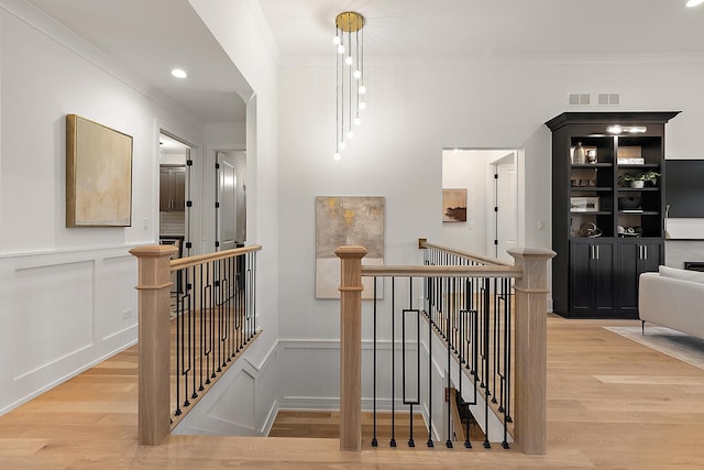 11060 Lizmore Ln Unit 27B, Orland Park, IL 60467 - staircase featuring wood finished floors, crown molding, a decorative wall, a wainscoted wall, and recessed lighting