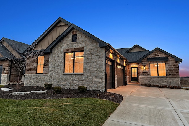 11060 Lizmore Ln Unit 27B, Orland Park, IL 60467 - view of front of home with board and batten siding, stone siding, driveway, a garage, and a front yard