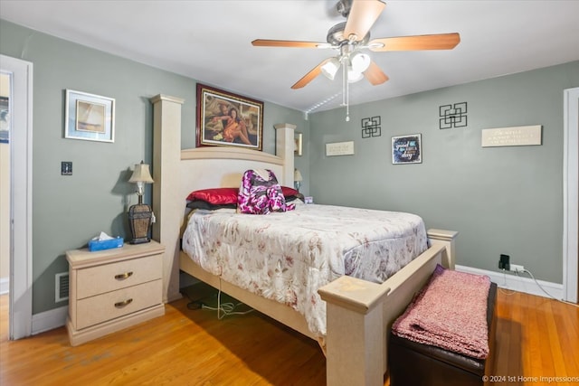 bedroom with light hardwood / wood-style floors and ceiling fan