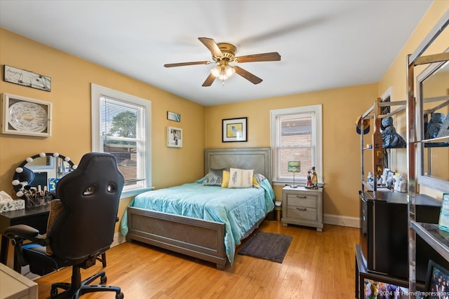 bedroom with light wood-type flooring and ceiling fan