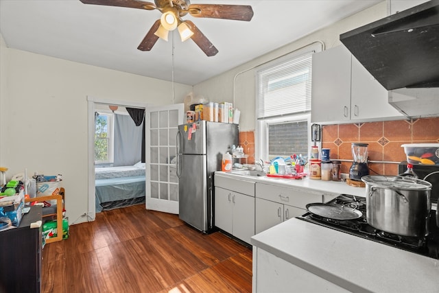 kitchen with ventilation hood, a wealth of natural light, and white cabinetry