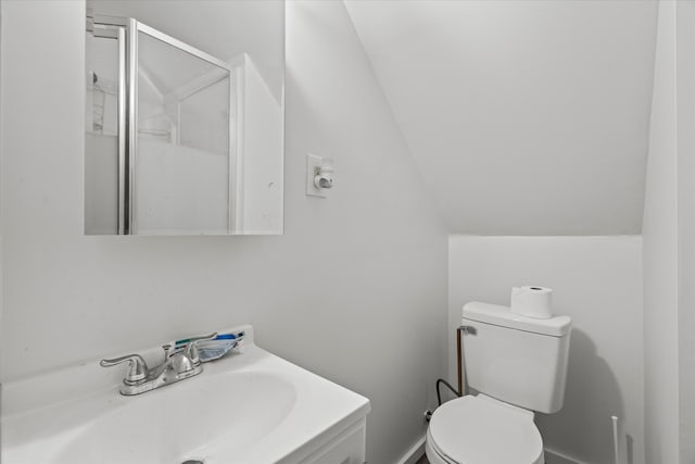 bathroom featuring vaulted ceiling, vanity, and toilet