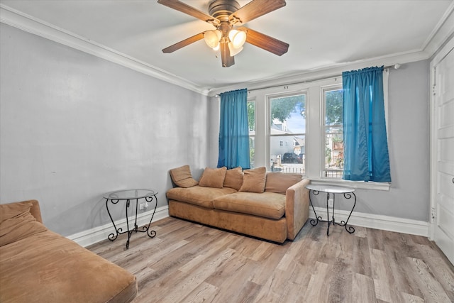 living room with light hardwood / wood-style flooring, ceiling fan, and ornamental molding