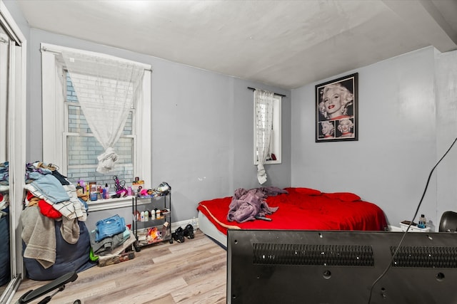 bedroom with hardwood / wood-style flooring