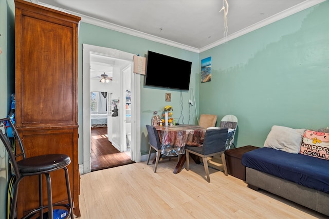 sitting room with ornamental molding, ceiling fan, and light hardwood / wood-style flooring