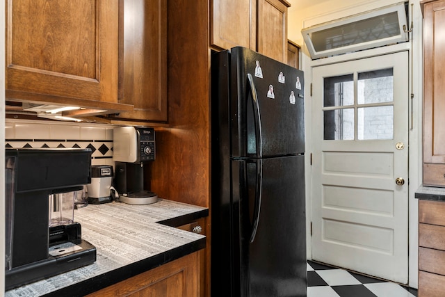 kitchen with black refrigerator