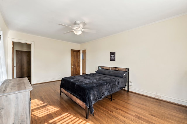 bedroom with ceiling fan, hardwood / wood-style flooring, and crown molding