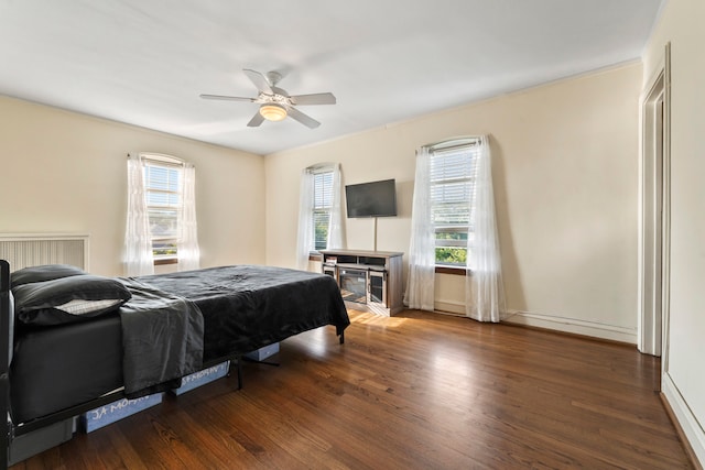 bedroom with ceiling fan and dark hardwood / wood-style floors