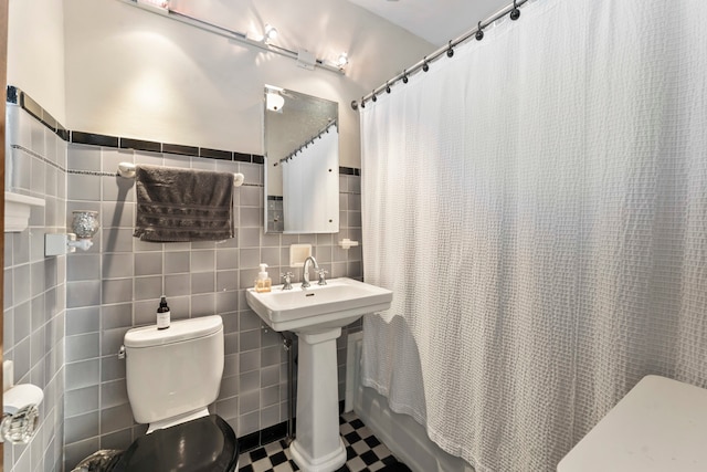 full bathroom featuring shower / bath combination with curtain, tile walls, tile patterned flooring, sink, and toilet