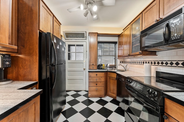 kitchen with black appliances, sink, ceiling fan, and tasteful backsplash