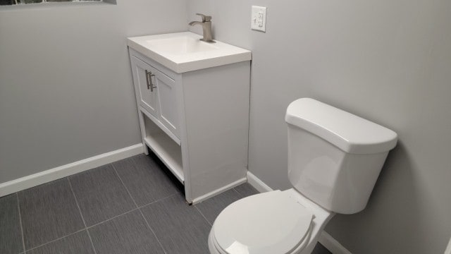 bathroom with vanity, toilet, and tile patterned floors