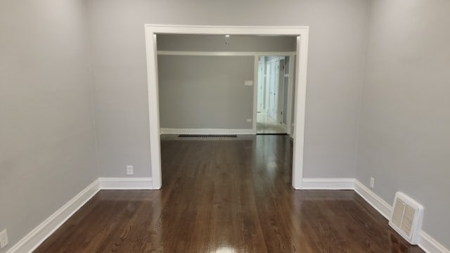 hallway with dark hardwood / wood-style floors