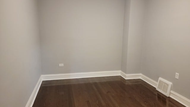 unfurnished room featuring dark wood-type flooring