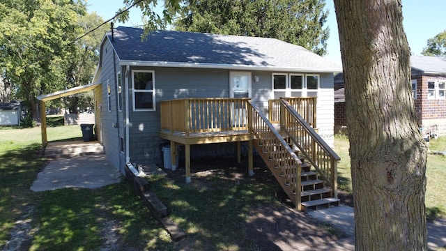 530 E Ash St, Watseka, IL 60970 - rear view of house with a yard, a shingled roof, a deck, and stairs