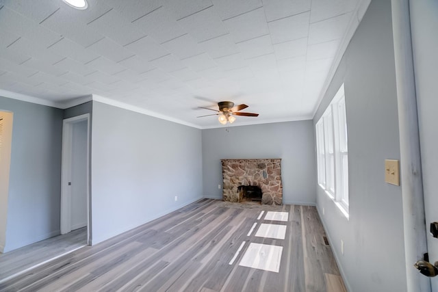 530 E Ash St, Watseka, IL 60970 - unfurnished living room featuring crown molding, baseboards, a ceiling fan, and light wood-type flooring