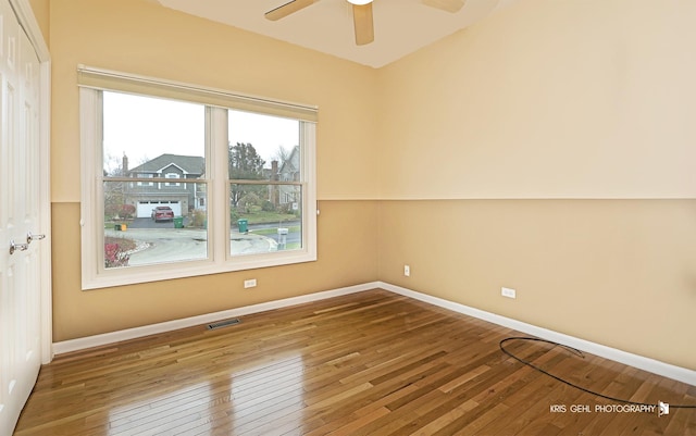 unfurnished room featuring ceiling fan and hardwood / wood-style flooring