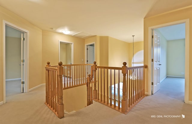 hallway with light colored carpet