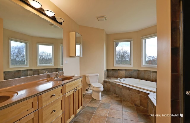 bathroom featuring a wealth of natural light, tile patterned flooring, vanity, and toilet