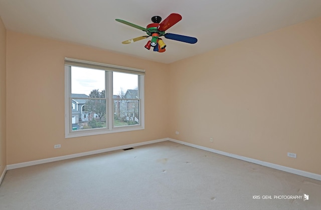 unfurnished room featuring light carpet and ceiling fan