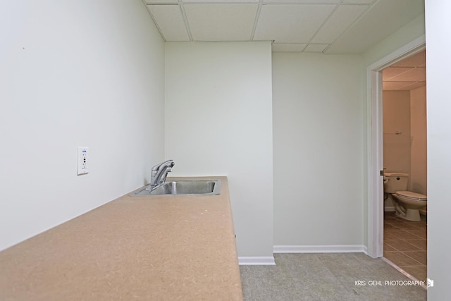 interior space with light tile patterned flooring and sink