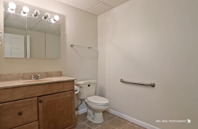 bathroom with tile patterned flooring, vanity, and toilet