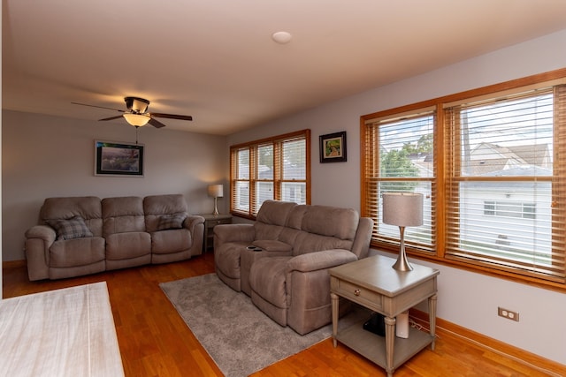 living room with wood-type flooring and ceiling fan