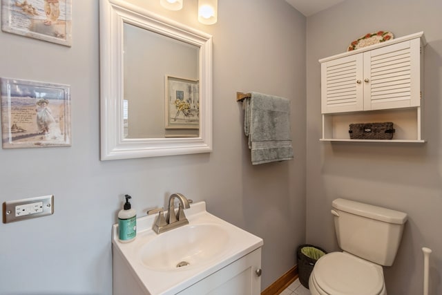 bathroom featuring tile patterned floors, vanity, and toilet