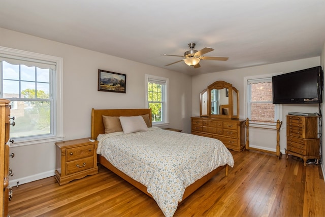 bedroom with ceiling fan and hardwood / wood-style flooring