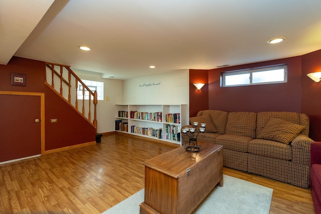 living room featuring a healthy amount of sunlight and light hardwood / wood-style flooring