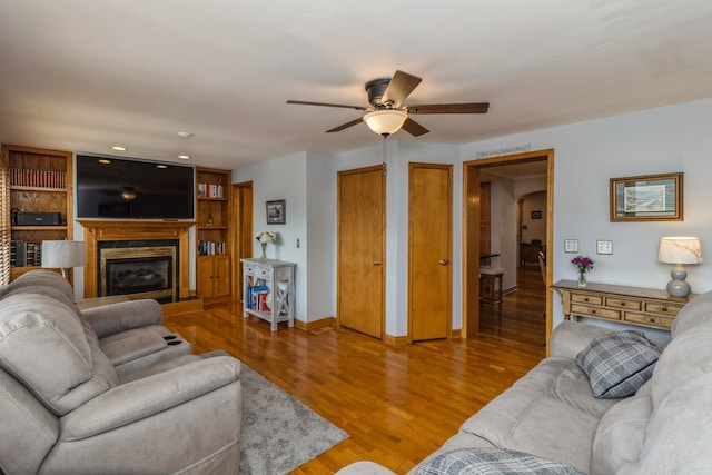 living room featuring ceiling fan and hardwood / wood-style floors